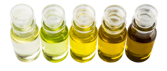 Avocado fruit oil, sesame seed oil, olive oil, grape seed oil and corn oil in vial glass bottle over white background © akulamatiau