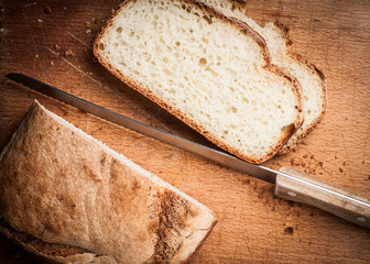 Wooden board sliced white bread and knife 