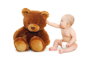 Cute baby playing with big teddy bear on white background