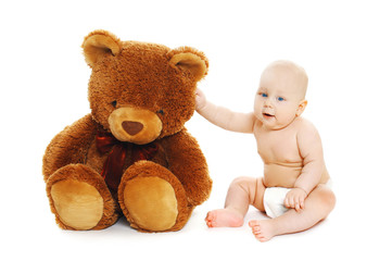 Cute baby sitting with big teddy bear on white background