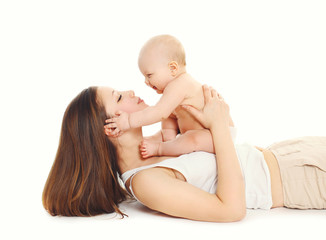 Happy mother playing with little baby on a white background