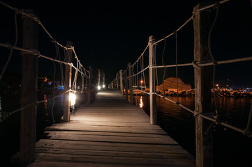 Wooden bridge to Cameo Island at night