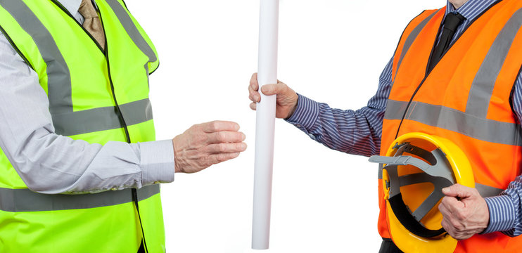 Two site surveyors in high visibility vests handing over site plans