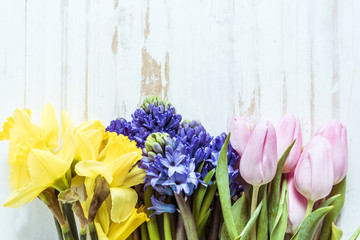 Springtime fresh flowers from above, on wooden table