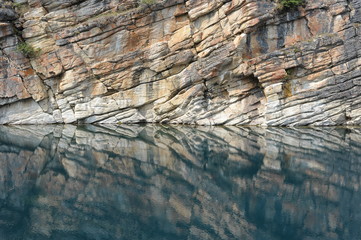 Cliff side reflection at Horseshoe Lake in Jasper National Park