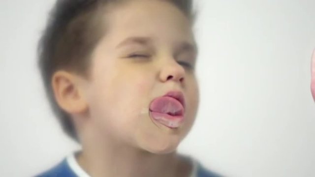 Naughty child making funny faces and having fun in slow motion