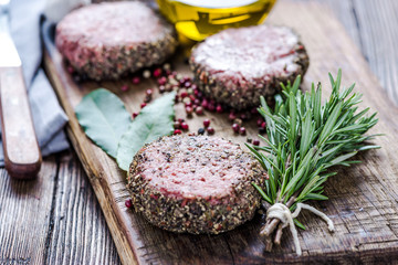 Raw beef burgers with herbs