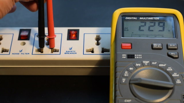 Measuring AC voltage with a digital meter.