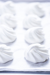 White homemade meringue on baking paper