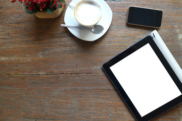Modern working place on grey wood table. From above view on the well equipped working place blank notepad and cup of fresh coffee