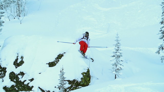 Low angle view of skier jumping from the hill and falling in the snow