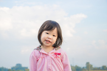 Little Asian girl looking at camera