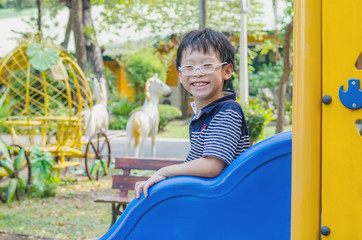 Fototapeta na wymiar Young asian boy plays at playground
