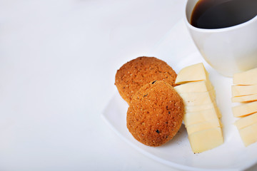 cup of coffee with chease and oat cookies