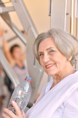 Elderly woman exercising in gym