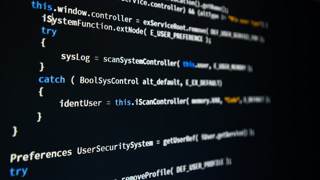 Software developer programming code. Abstract computer script code. Shallow depth of field, selective focus effect.