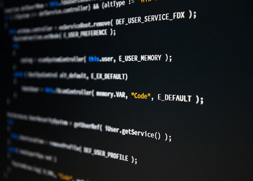 Software developer programming code. Abstract computer script code. Shallow depth of field, selective focus effect.