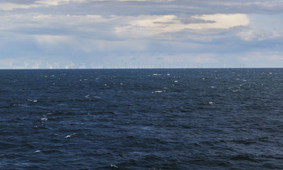 Windmills on the horizont surrounding by sea