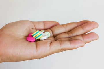Medicine, pill in hand on white background