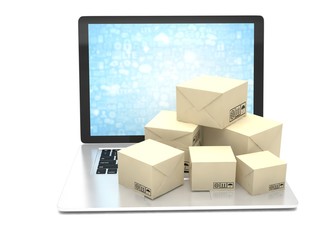 Technology business concept, shipping: cardboard package boxes on laptop