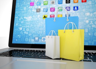 laptop and  shopping pags on white background