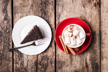 Fototapeta na wymiar Hot chocolate with marshmallow and piece of cake