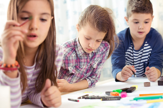 Child painting at easel in school