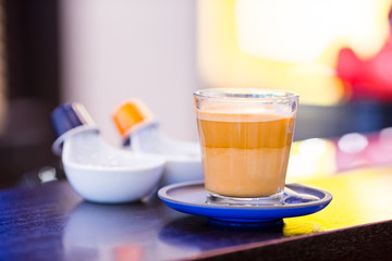 Cup of delicious fragrant Express in coffee shop
