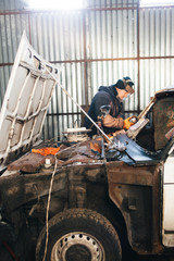 Fototapeta na wymiar Mechanic repair and service car in garage