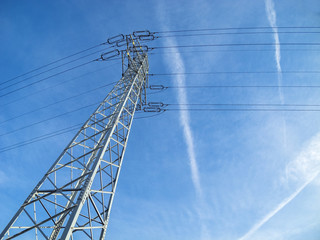 High voltage pylon against blue sky