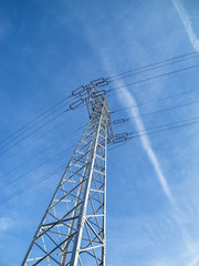 High voltage pylon against blue sky