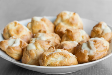 Delicious profiteroles in a plate.