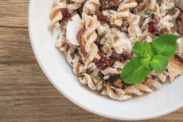Pasta dish with dried tomatoes, mushrooms and bechamel sauce.