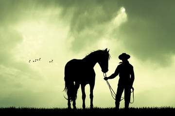 Obraz na płótnie Canvas Man and horse at sunset