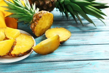 Ripe pineapples on a blue wooden background