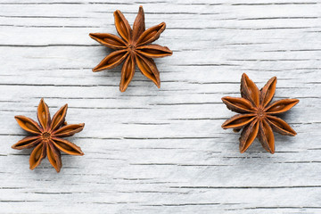 Spices. Anise stars on the vintage wooden background 