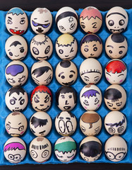 Children's craft of faces drawn on eggs