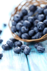 Blueberries in basket on a blue wooden table