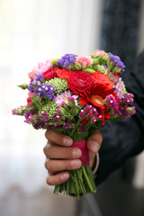 beautiful Bridal bouquet in the hand of the groom