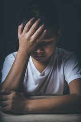 scared and alone, young Asian child who is at high risk of being bullied, trafficked and abused