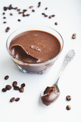 Homemade chocolate and coffee cream in glass jar, selective focus