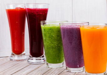 Healthy Colorful Smoothies with Fruits and Vegetables Against a Rustic Wooden Background. Various Freshly Squeezed Juices for Detox