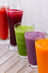 Healthy Colorful Smoothies with Fruits and Vegetables Against a Rustic Wooden Background. Various Freshly Squeezed Juices for Detox