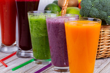 Healthy Colorful Smoothies with Fruits and Vegetables Against a Rustic Wooden Background. Various Freshly Squeezed Juices for Detox