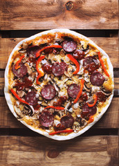 Tasty italian pizza on rustic wooden background
