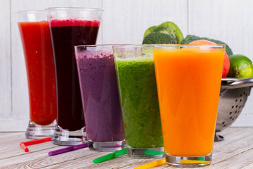 Healthy Colorful Smoothies with Fruits and Vegetables Against a Rustic Wooden Background. Various Freshly Squeezed Juices for Detox