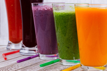 Healthy Colorful Smoothies with Fruits and Vegetables Against a Rustic Wooden Background. Various Freshly Squeezed Juices for Detox