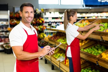 Grocery store staff with clipboard