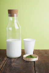 full milk bottle, matcha, paper glass on green back