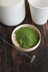 milk bottle, froather, matcha, paper glass on table